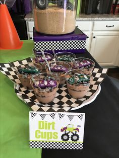 desserts on a table with dirt cups in the middle