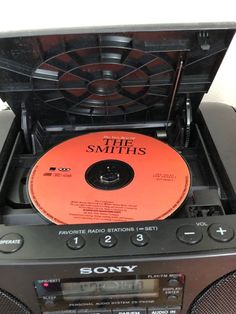 a cd player with an orange disc in it