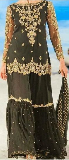 Product Description:  Have your dream look with this luxurious Black Gharara set. Intricate gold hand-worked with beautifully embellished duppatta. Color: Black Can be customized in any color Includes:  Gharra Set Duppata Elegant Black Floor-length Palazzo Set, Gold Embroidered Palazzo Set For Festivals, Elegant Palazzo Set With Gold Embroidery, Traditional Gold Palazzo Set With Gold Embroidery, Elegant Gold Embroidered Palazzo Set With Traditional Drape, Elegant Gold Palazzo Set With Embroidery, Festival Gold Sharara With Gold Embroidery, Elegant Gold Palazzo Set With Gold Embroidery, Gold Sharara With Gold Embroidery For Festivals