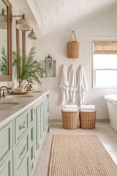 a white bathroom with two towels hanging on the wall and a bathtub in the corner