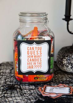 a jar filled with candy sitting on top of a table