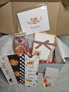 a box filled with lots of different cards and paper goods on top of a table