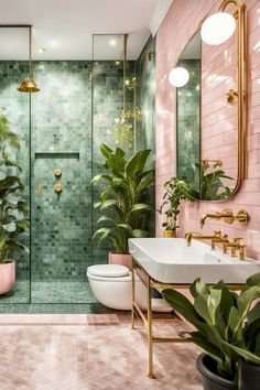 a bathroom with pink tiles and green plants on the walls, along with a white toilet and sink