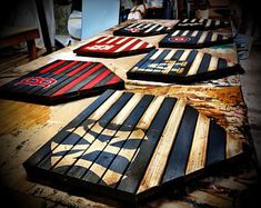 several wooden boards sitting on top of a table covered in red, white and blue stripes