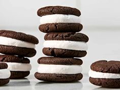 chocolate cookies and marshmallows stacked on top of each other with white frosting