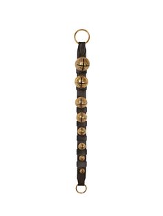 a black and gold bracelet with metal beads on it's end, in front of a white background