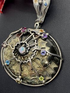 "ARTISAN AMMONITE PENDANT Hand-made Sterling Silver. Stones used: Ammonite, Mixed color Sapphires, Peridote, Amethyst, Citrine, Garnet, Blue Topaz, Australian Opal. Height - 70mm, Width - 50mm. Unique Handcrafted One-of a-kind Design Pendant Each Piece of Jewelry in my Collection is Absolutely One of a Kind! When you start wearing a piece of my jewelry you will fall in love with it more and more each day and feel that good Energy and Love that I pass into it while creating this piece of Art. A p Luxury Handmade Round Gemstones, Multicolor Gemstones For Formal Occasions, Unique Multicolor Gemstones For Formal Occasions, Artistic Multicolor Jewelry For Formal Occasions, Artistic Multicolor Jewelry For Formal Events, Artistic Multicolor Formal Jewelry, Handmade Multicolor Gemstones For Formal Occasions, Formal Handmade Multicolor Gemstones, Ammonite Pendant