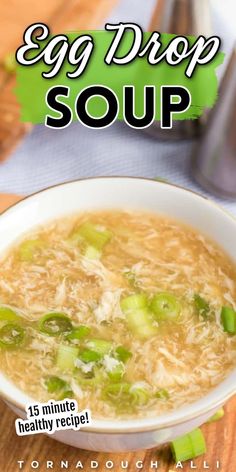 an egg drop soup recipe in a white bowl with green onions and celery