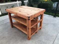 a wooden table sitting on top of a sidewalk