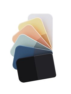 a stack of different colored cards sitting next to each other on top of a white surface