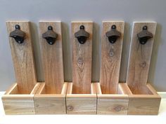 four wooden pegs are lined up in a row with black knobs on them