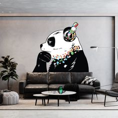 a panda bear with headphones on sitting in front of a couch and coffee table