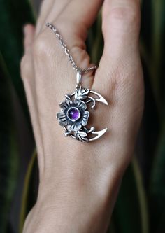 The Blooming Moon pendant is made entirely by hand in sterling silver with purple amethyst. It symbolizes an ode to life and femininity.  This wildflower Moon necklace is about women. They, like spring, harbor a bottomless creative power, giving life to new and beautiful things again and again. The Moon patronizes this power. The size of the pendant is about 0.98 х 1.02 inches (2.5 x 2.6 cm). This piece of jewelry is oxidized and polished. The price is for 1 pendant without the ring. You can find the matching ring from the photo here: https://jewelrybymirraling.etsy.com/listing/1051682918 Moon jewelry https://www.etsy.com/shop/JewelryByMirraling?ref=seller-platform-mcnav&sort_order=date_desc&search_query=moon Amethyst jewelry: https://www.etsy.com/shop/JewelryByMirraling?ref=seller-platfor Handmade Crescent Sterling Silver Jewelry, Purple Sterling Silver Flower Pendant Jewelry, Mystical Sterling Silver Moon Charm Jewelry, Amethyst Flower Pendant Jewelry Gift, Sterling Silver Moon Charm Jewelry, Amethyst Flower Pendant Jewelry For Gift, Handmade Moon Shaped Amethyst Jewelry, Mystical Silver Amethyst Necklaces, Purple Sterling Silver Flower Pendant Necklace