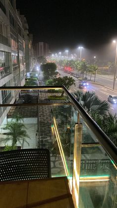 an empty balcony overlooking the street at night