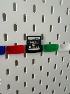 a close up of a memory card attached to a white wall with holes in it