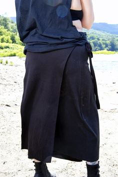 This edgy, black loincloth is an amazing layering piece for both performance costumes and everyday styling. Crafted from a soft and stretchy cotton blend fabric, it is detailed with the druidic cosmos symbol for an eye-catching finish. I use a dye removal process so every piece has its own one-of-a-kind traits and the symbol won't fade.The panel skirt is made of two separate rectangles that tie on the sides making it very adjustable. I have options for the length and width of each panel. When de Black Skirt For Cosplay, Black Bohemian Cotton Skirt, Black Cotton Bohemian Skirt, Fitted Black Lagenlook Bottoms, Black Cotton Wrap Skirt For Summer, Black Long Skirt For Festival, Black Cotton Skirt For Festival, Black Long Bohemian Wrap Skirt, Bohemian Black Long Wrap Skirt