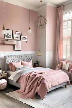 a bedroom decorated in pink and white with a large bed, two chairs, pictures on the wall and a chandelier hanging from the ceiling