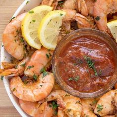 a white bowl filled with shrimp and sauce