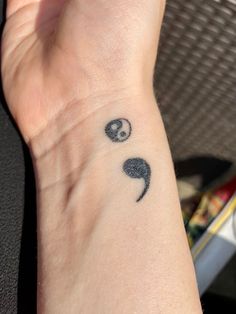 a person's wrist with a tattoo on it that has an image of two pandas