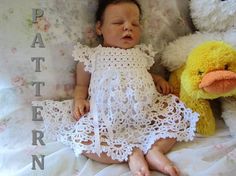 a baby sleeping next to a stuffed duck