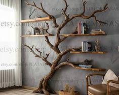 a living room with bookshelves and a tree in the corner that is made out of wood