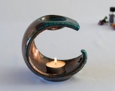 a candle holder with a crescent shaped candle