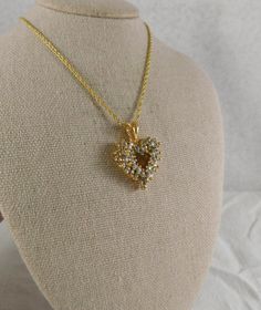 Sparkling CZ's adorn this beautiful openwork gold plate heart necklace made by Roman's. .  Pendant is 1 by 3/4 inches and the chain is 18. 43 cz's...none missing. Stamped "Roman" on the back of the bail of the pendant. It does not have the original chain on itvery slight difference in shades of gold. Beautiful pristine condition. Cubic Zirconia Heart Pendant Jewelry With Heart Beads, Open Heart Jewelry For Valentine's Day Jewelry Making, Gold Cubic Zirconia Heart Pendant Necklace, Gold Cubic Zirconia Heart Cut Jewelry, Gold Cubic Zirconia Jewelry In Heart Cut, Gold Heart Pendant Necklace With Cubic Zirconia, Gold Heart Cut Cubic Zirconia Jewelry, Heart Cut Cubic Zirconia Gold Jewelry, Gold Cubic Zirconia Heart Pendant Jewelry