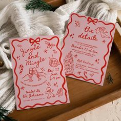 two red and white wedding cards on top of a wooden tray next to some yarn