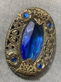 vintage Czech brass filigree sapphire blue rhinestone diamanté brooch 6.5cm Antique Blue Jewelry With Brooch, Blue Oval Brooch Jewelry, Oval Blue Brooch Jewelry, Blue Oval Brooch For Gifts, Oval Blue Brooch, Blue Oval Brooch, Blue Victorian Brooch For Formal Occasions, Blue Victorian Brooches For Formal Occasions, Victorian Blue Brooch For Formal Occasions