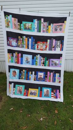 a quilt made to look like a bookshelf with pictures on the front and sides