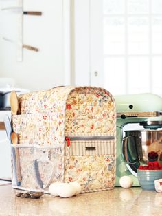 a kitchen counter with various appliances on top of it, including a mixer and blender