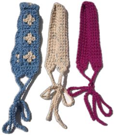 three crocheted headbands with bows are shown in different colors and sizes