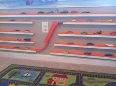 a child's room with toy shelves and toys on the floor