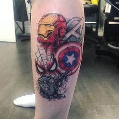 a person with a tattoo on their leg that has an image of captain america and iron man