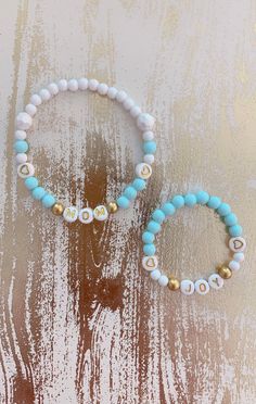 "This is a simple but elegant looking MOMMY & BABY bracelets. The bracelets are made with quality stretchy elastic and acrylic gumball beads. The gold mini spacer beads with gold letter beads are perfectly match for each other. This is the perfect baby shower gift for your best girlfriend, your wife or your daughter who is about to have a baby! You can have any names/words on the bracelets! Having a baby Boy? Check out our boy styles here 👉🏻 https://etsy.me/3dfziz6 🌟 Special Edition of Mo Flexible White Stretch Bracelet As Gift, Personalized White Flexible Bracelets, Personalized Flexible White Bracelets, White Round Beads Stretch Bracelet For Birthday, White Stackable Name Bracelet For Birthday, White Stretch Bracelet With Letter Beads For Birthday, White Stackable Stretch Bracelet For Birthday, White Adjustable Stretch Bracelet For Personalized Gift, Cute White Stretch Bracelet For Personalized Gift