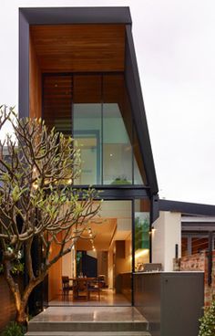 a modern house with an outdoor patio and dining area