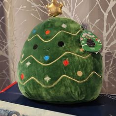 a green stuffed christmas tree on top of a table