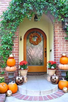 an entrance with pumpkins and potted plants