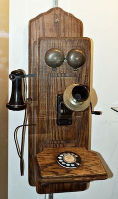 an old fashioned wooden phone is on display