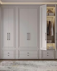 a large white closet with many drawers and shelves in the middle, along with an area rug on the floor