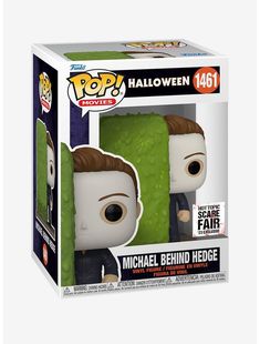 a pop vinyl figure in a box with an image of michael behind the green wall