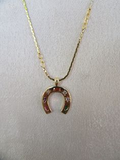 90s rhinestone horseshoe necklace. Multicolor rhinestone encrusted horseshoe on gold tone chain. Chain is 23" total Charm is 3/4" x 5/8" No noted flaws. So cute Horseshoe Pendant, Horseshoe Necklace, Luck Charm, Luck Charms, Good Luck, Chains Necklace, Necklace Etsy, Chain Necklace, Gold Tones