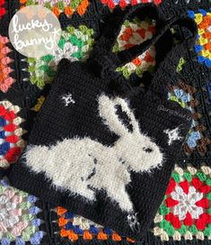 a crocheted bag with an image of a white rabbit on the front and bottom