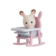 a small toy rabbit sitting in a baby's high chair