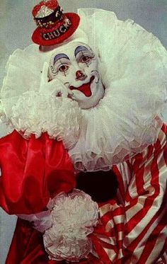 the clown is dressed in red and white