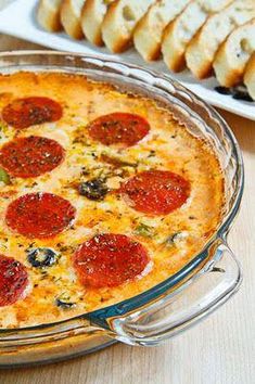 a pepperoni pizza in a glass dish next to slices of bread on a table