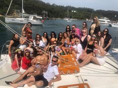 a group of people sitting on the back of a boat posing for a photo together