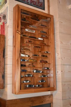 a wooden cabinet filled with lots of knives