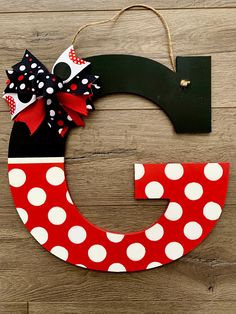 the letter c is decorated with polka dots and a minnie mouse bow on it's head