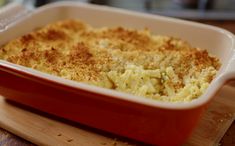 a casserole dish is sitting on a cutting board